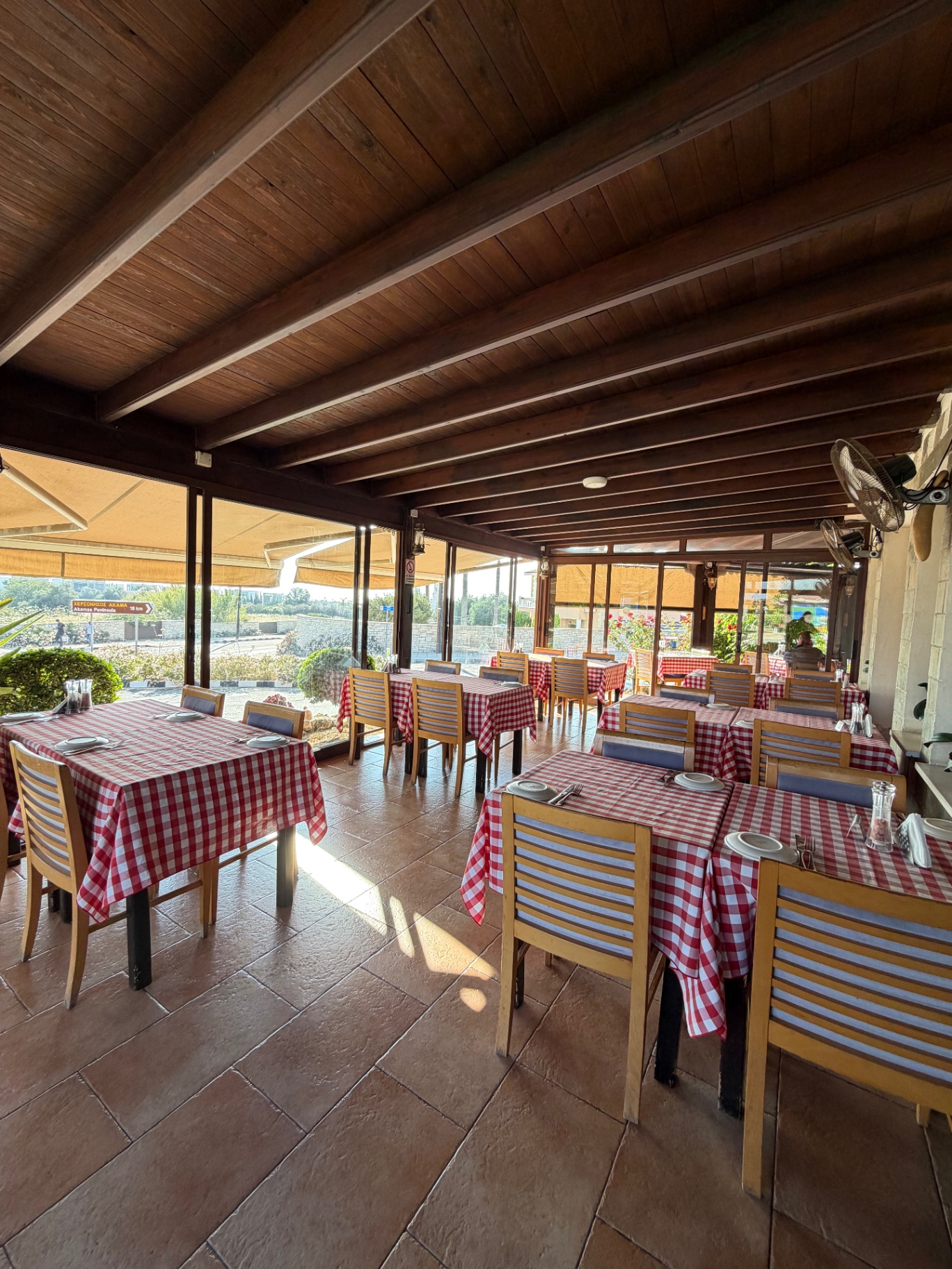 Indoor dining space at SUNSET Tavern with red checkered tablecloths